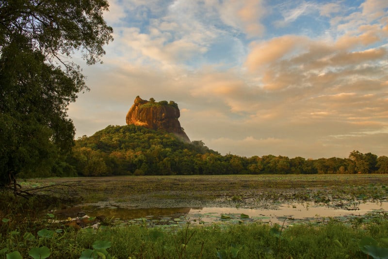 sigiriya-dusk-after-rain A view of Sigirya Rock Fortress from afar with a water body in between