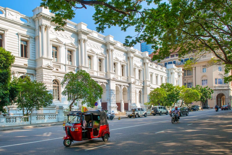Foreign Affairs Ministry Building Colombo White exterior of Foreign Affairs Ministry Building in Colombo with tuk tuk driving past
