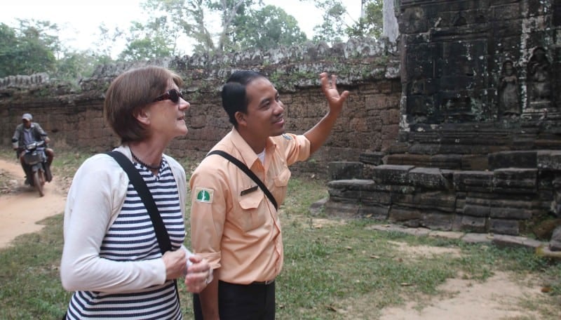 Guides Cambodia A guide talking to a traveller in cambodia whilst pointing at a monument