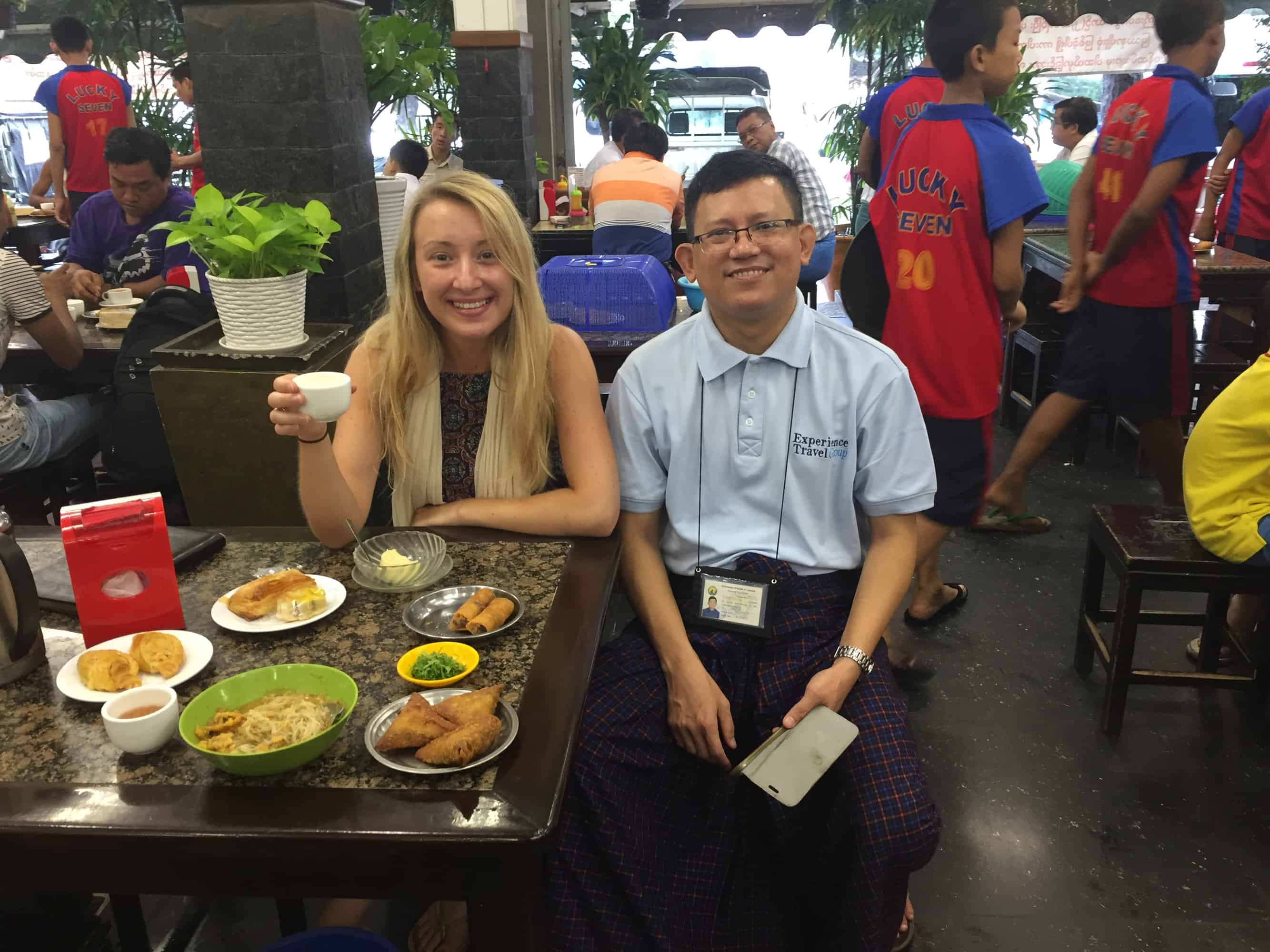 myanmar guide A guide and traveller sat together in a restaurant in myanmar