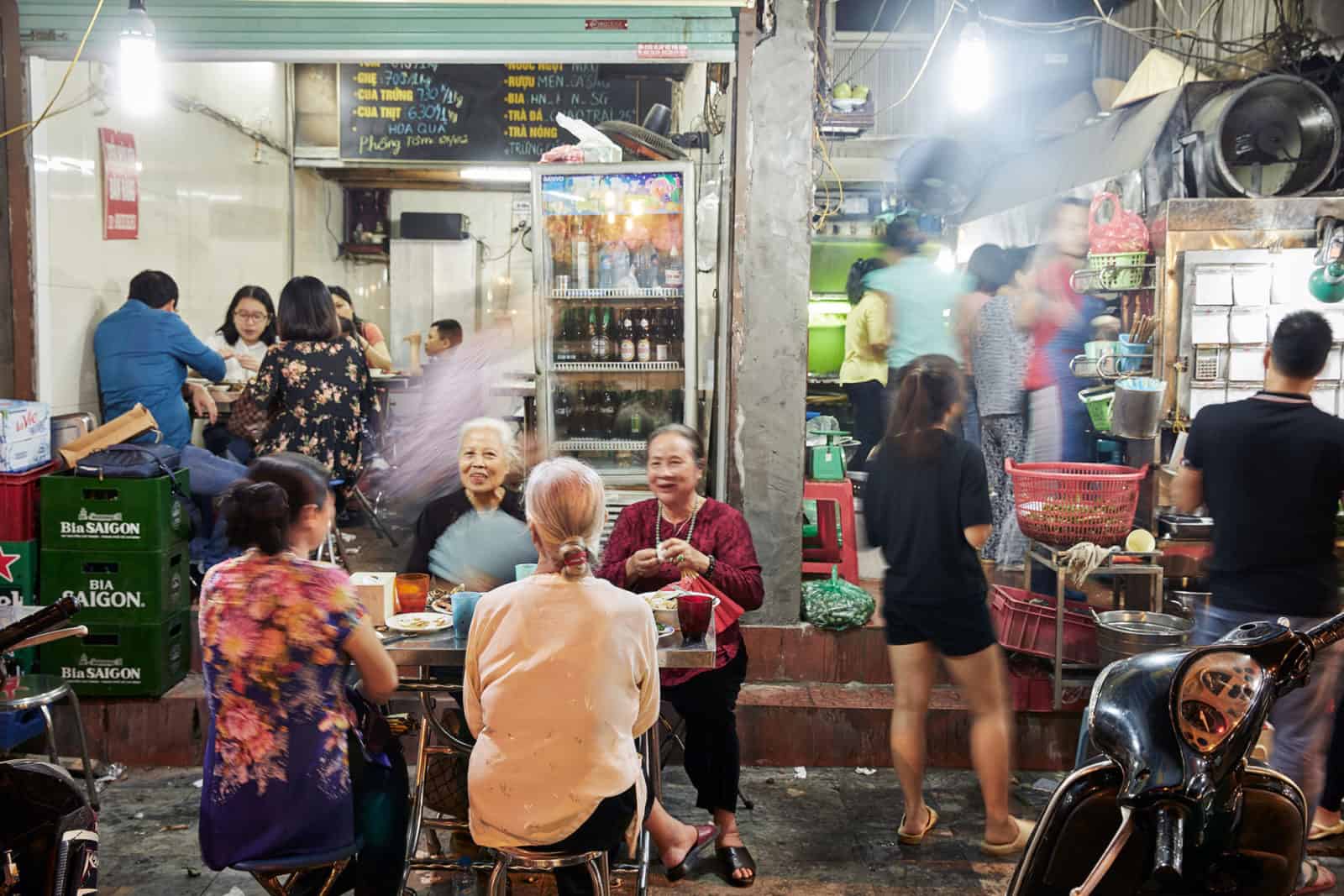 Hanoi street food scene Locals sat outside a cafe in Hanoi in the evening