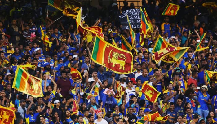 crowd Sri Lankan cricket fans celebrating and waving flags