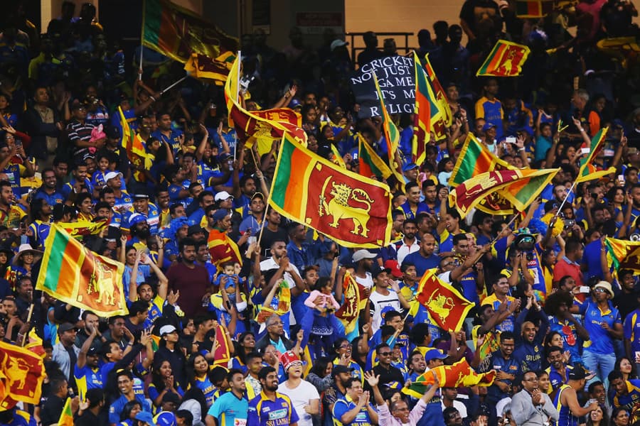 crowd Sri Lankan cricket fans celebrating and waving flags