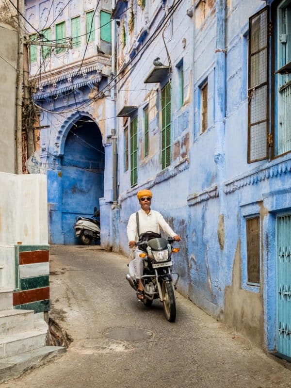 India-5 Moped rider in narrow alleyway in the blue city of Jodhpur