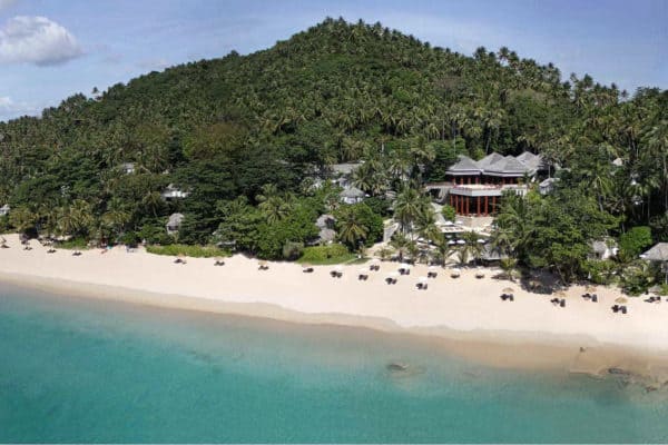 surin thailand View from above of the beach of Surin Phuket. Clear blue sea, white sand beach and forest clad hill.