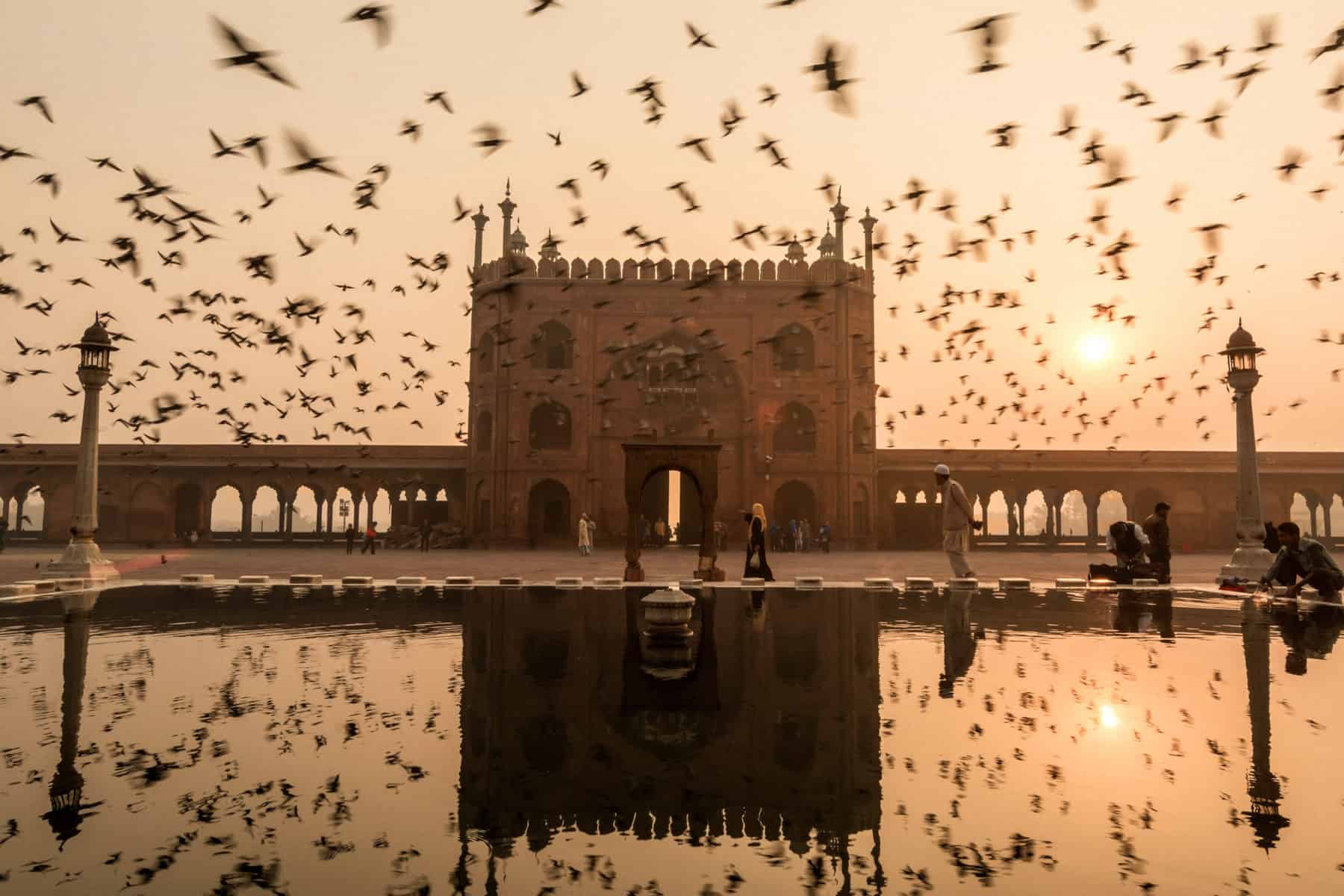 Reflection of Jama masjid, Old Delhi india during sunrise with Jama Masjid at sunrise in Delhi, Northern India