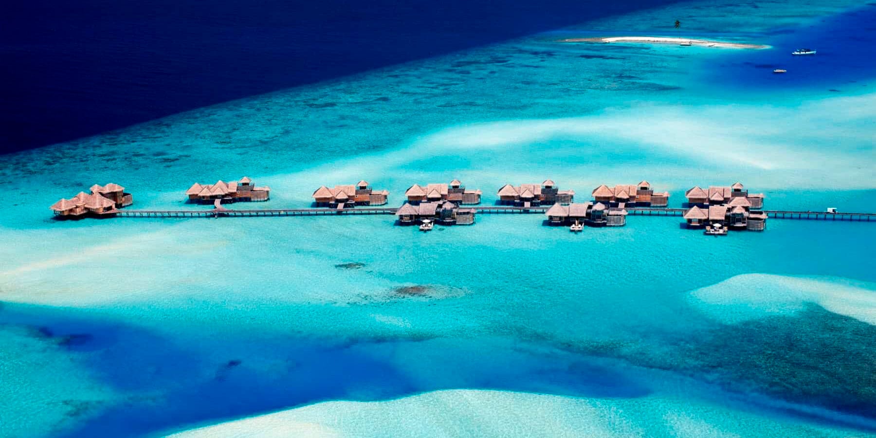 The Maldives Aerial view of overwater villas and turquoise ocean in the Maldives
