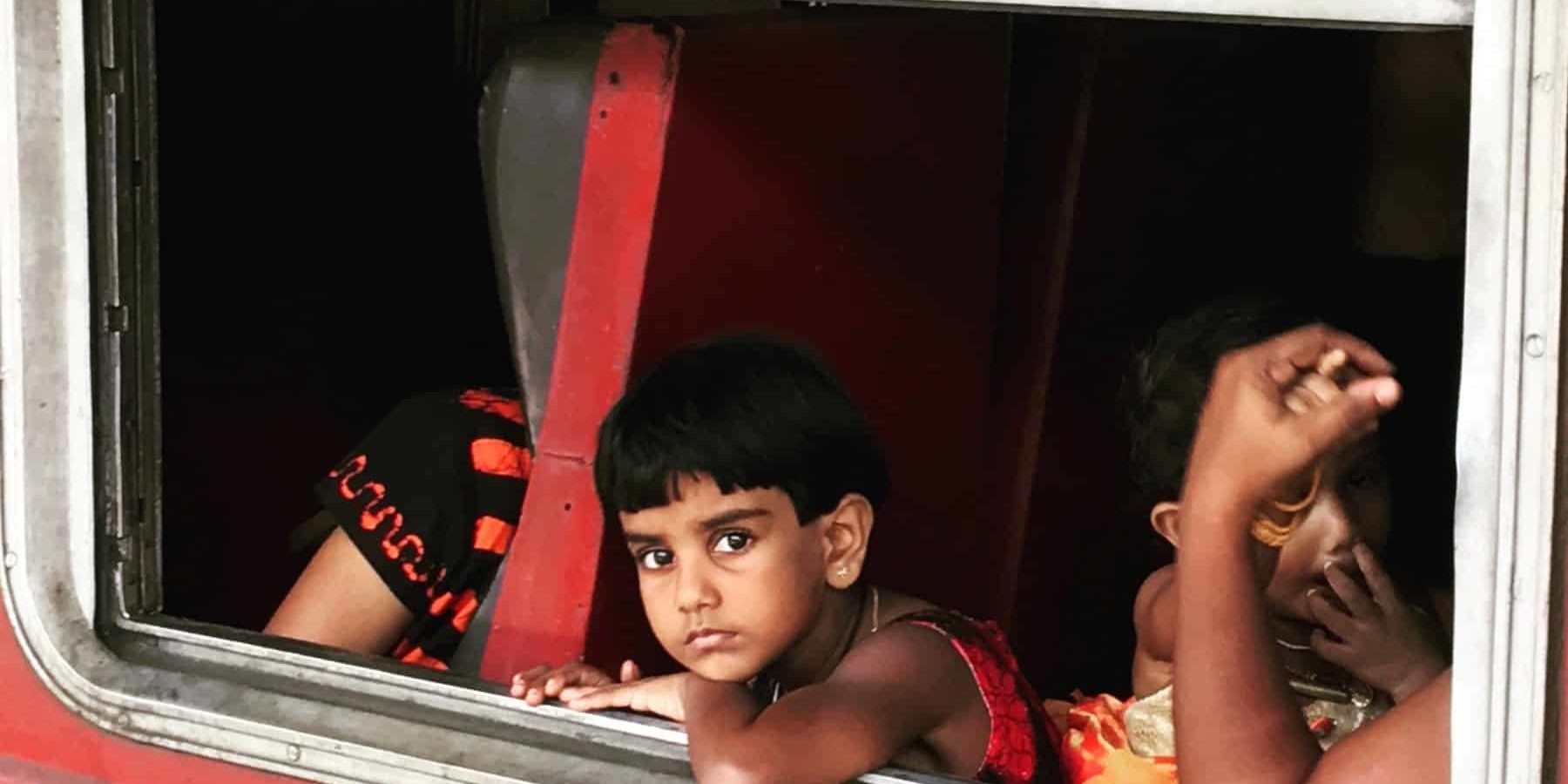 Child on train in India Child on train in India looking out of the window