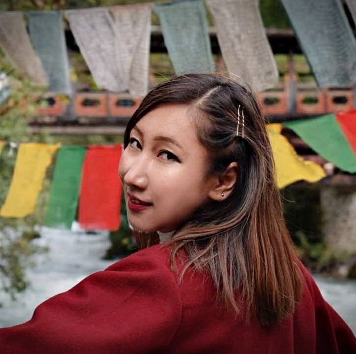 She Bhutan 5 Founder of Bhutanese fashion label Geymit Lepcha in front of prayer flags
