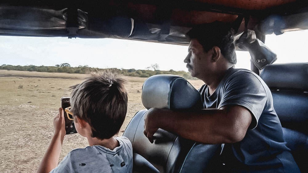 SriLanka10 A friendly guide helping a boy spot wildlife on a Sri Lanka Family Holiday with ETG