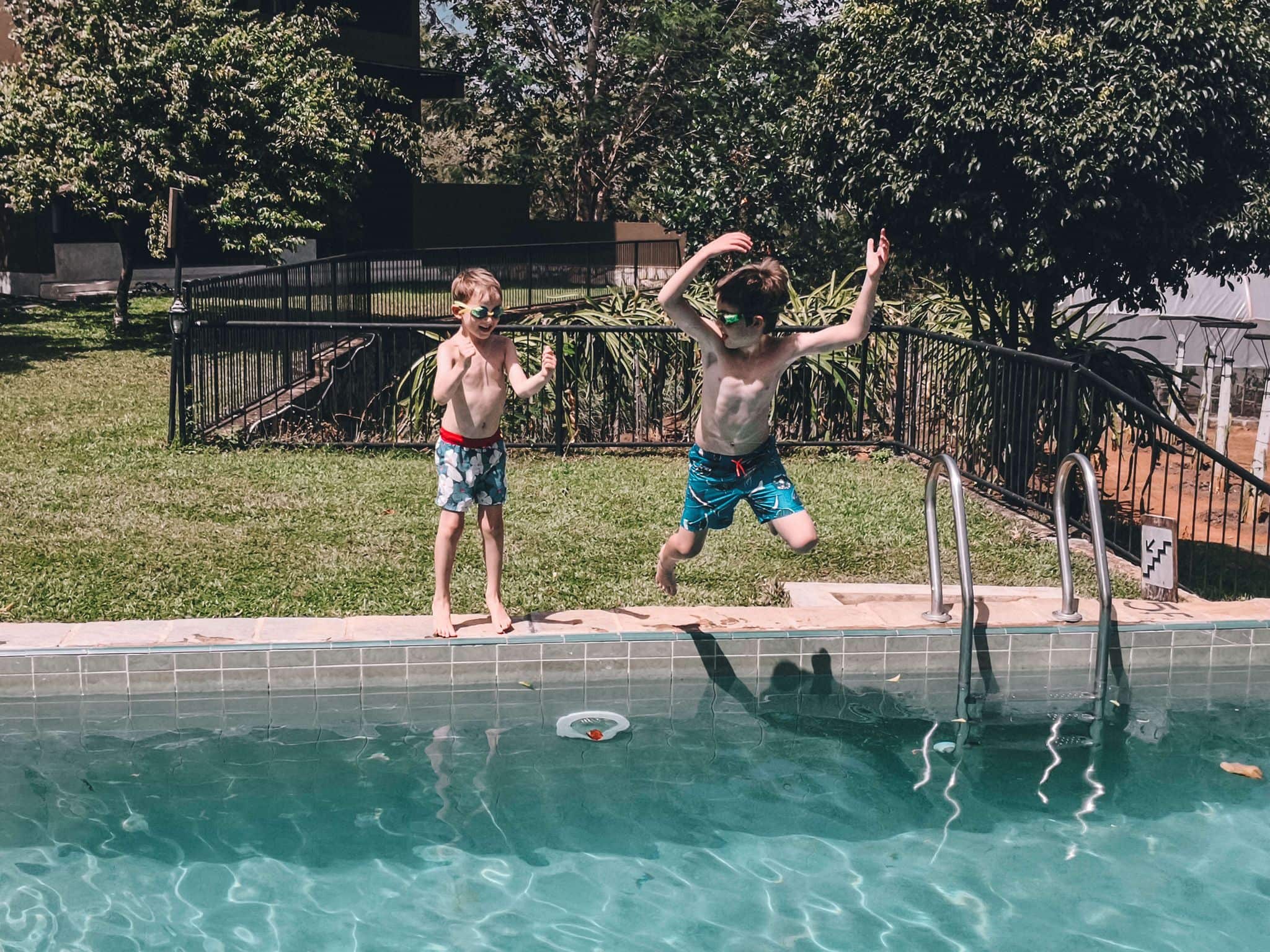 Family Travel Kids Pool Kids jumping into a pool on a family holiday to Asia