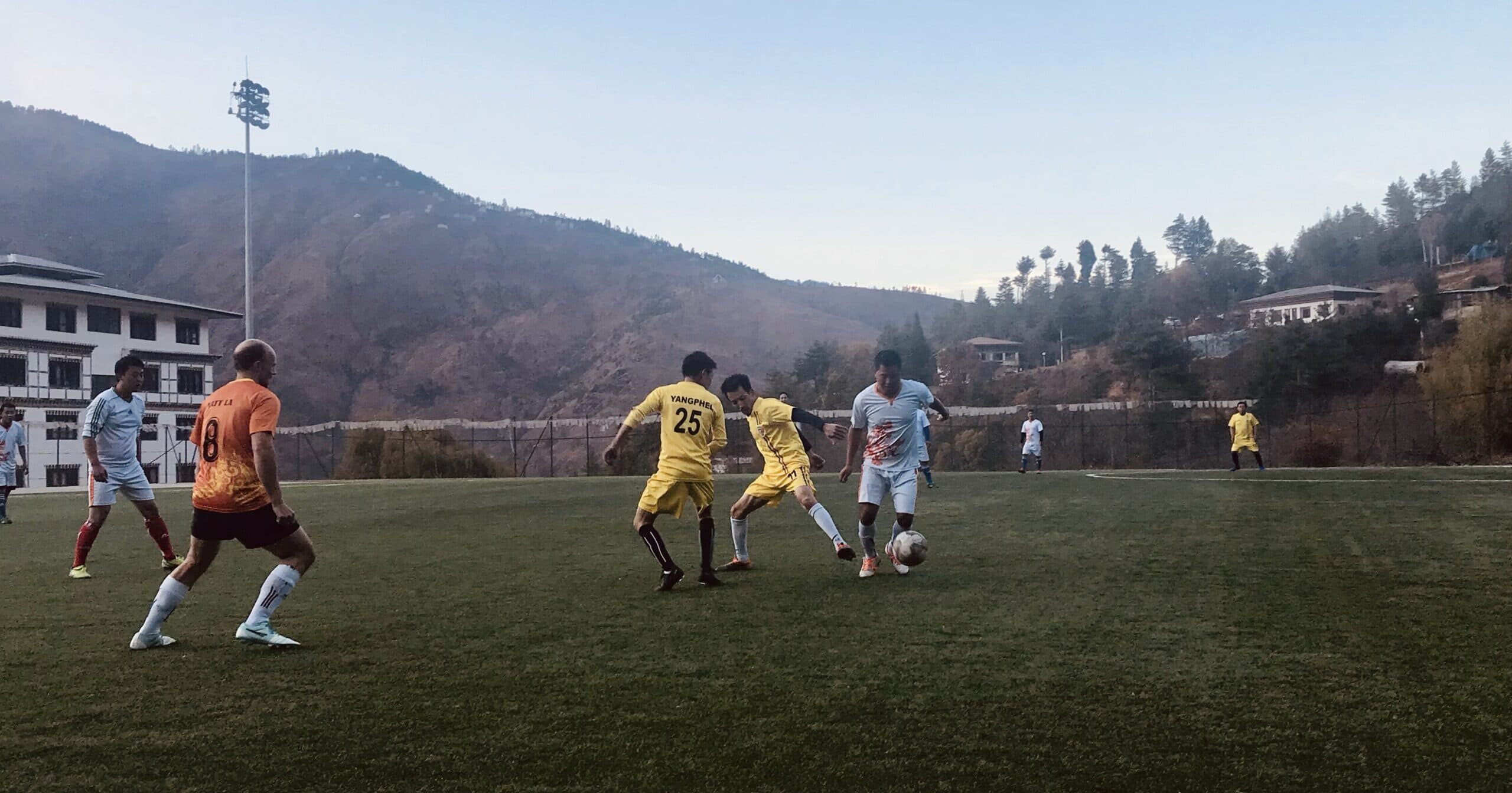 Matt playing football in Bhutan Football match in Bhutan