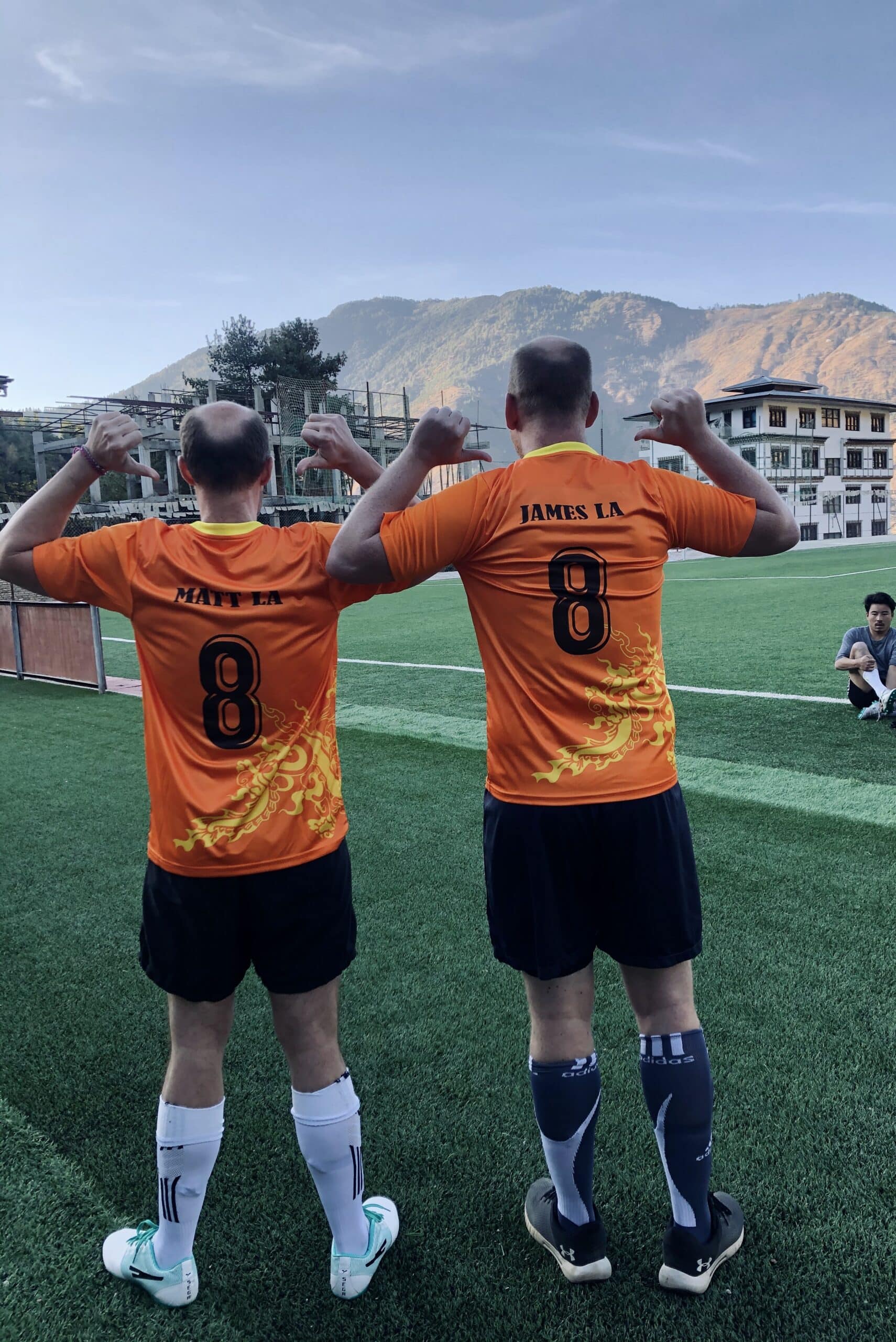Matt and James with personalised Kit Playing football in Thimphu, the capital city in Bhutan