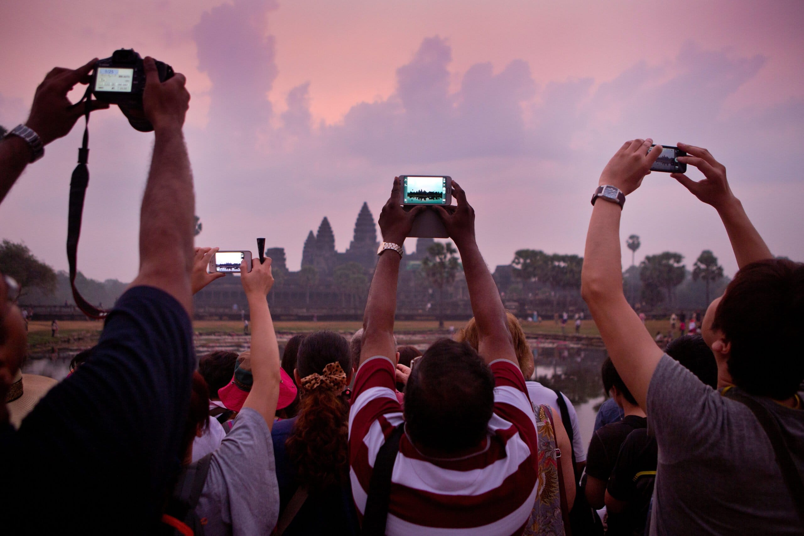 Photographing the dawn at Angkor Wat, waiting to see the light come up over the main temple of Angkor, Cambodia Taking a picture of Angkor Wat Sunrise