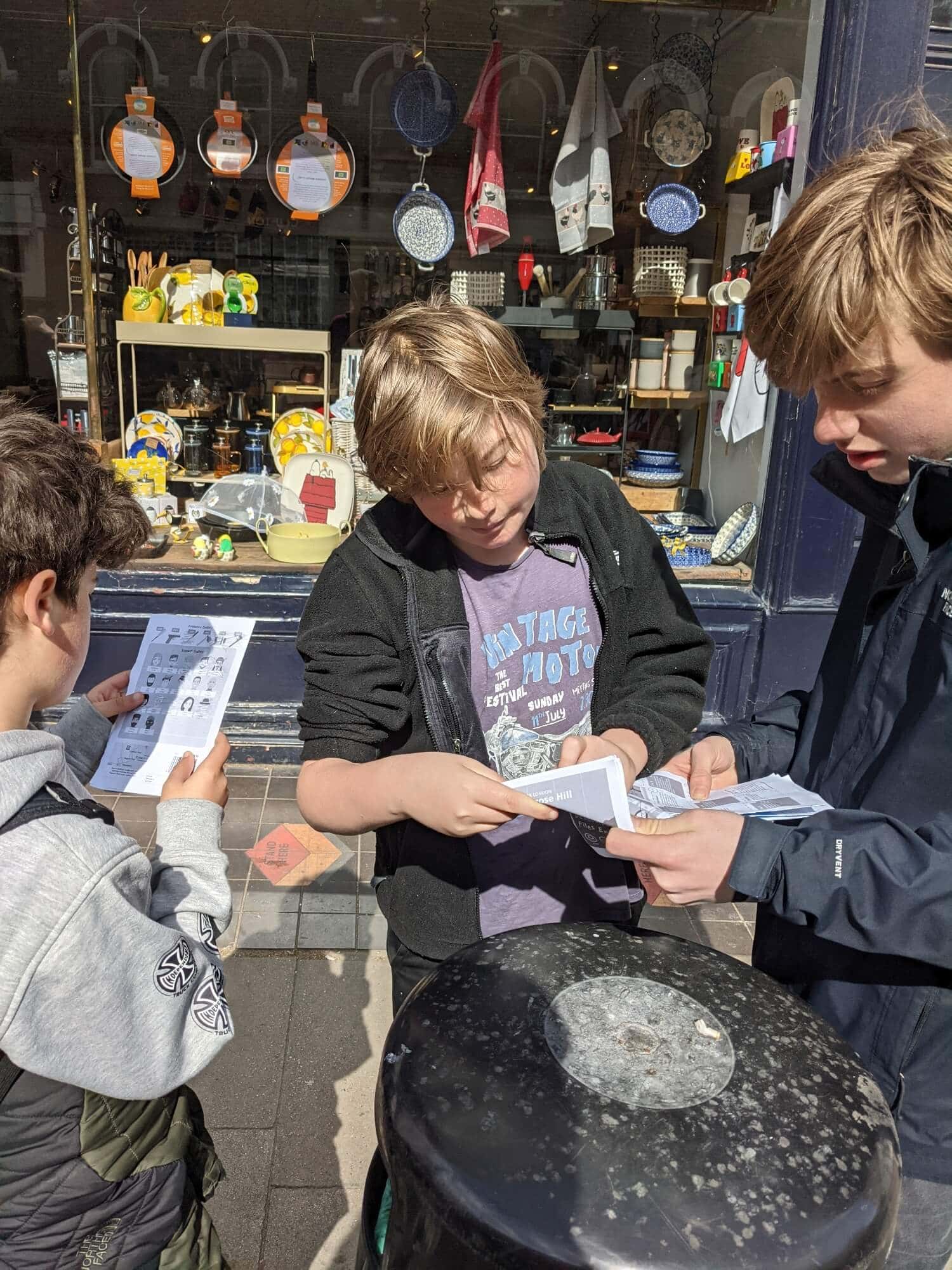 Eddy George Clark and Alec reading maps on a London street (1) Three teenage boys reading maps on a London street