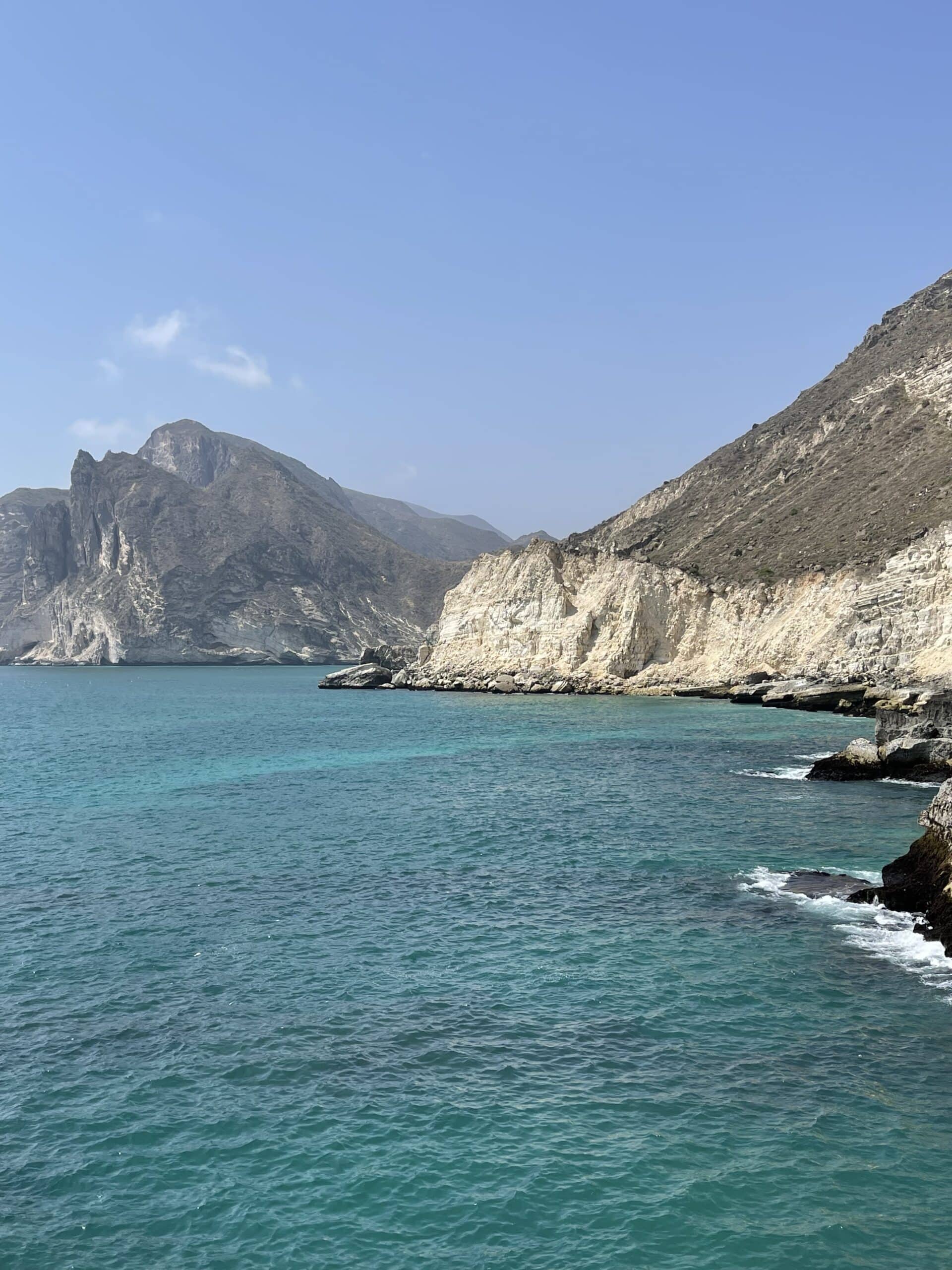 Stunning coastal scenery Turquoise waters and dramatic cliffs of Omans coastline