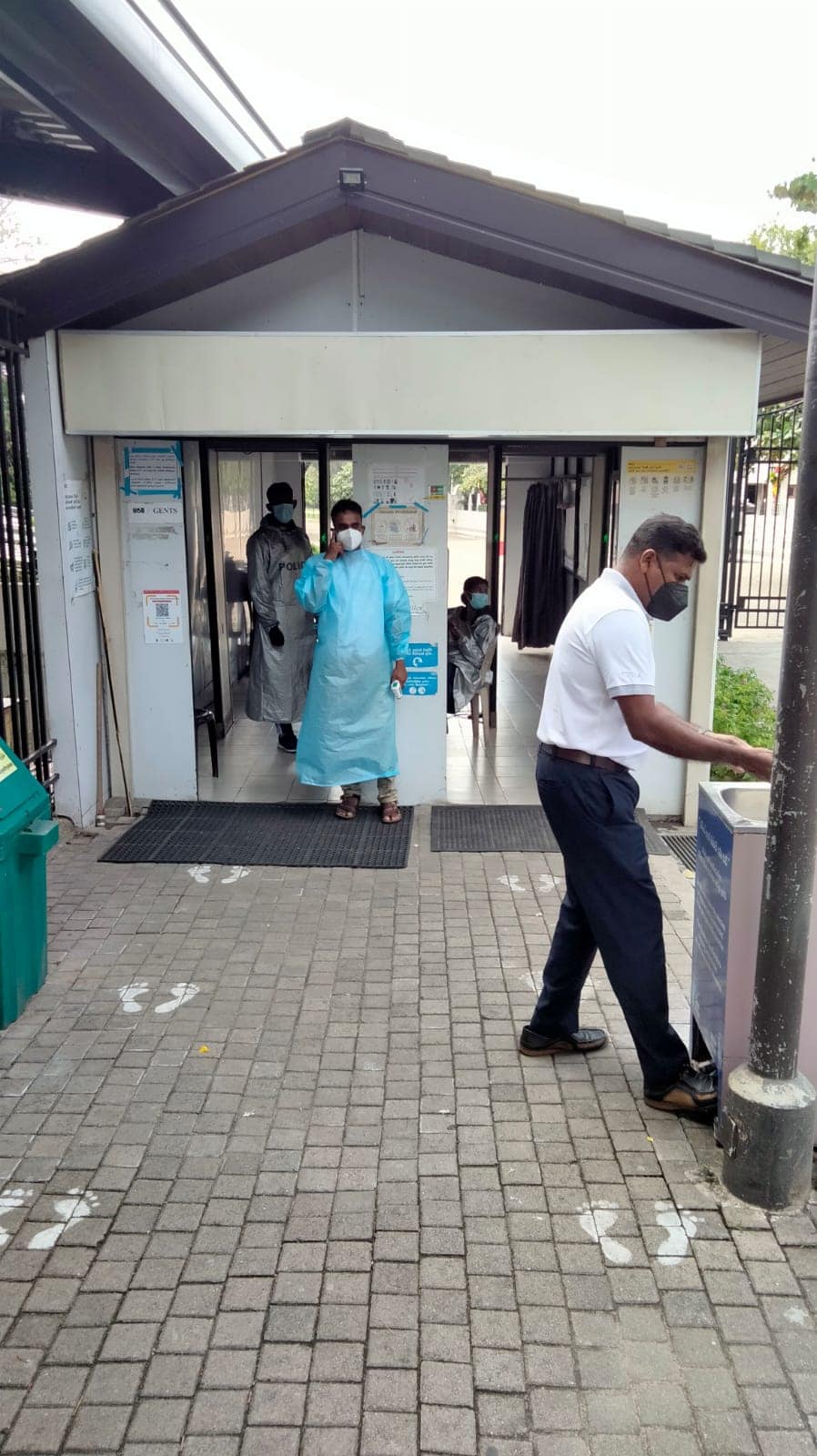 WhatsApp Image 2021-10-17 at 11.02.57 Staff outside Temple of the Tooth ensuring hand sanitising takes place and temperatures are logged