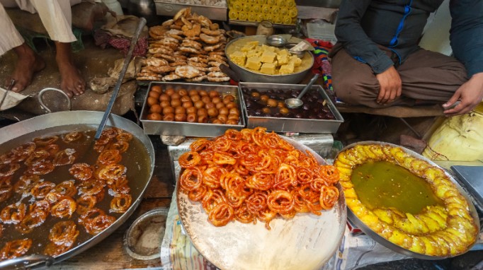 Street food stall cooking and serving Indian sweet dessertsStreet food stall cooking and serving Indian sweet desserts Street food stall cooking and serving Indian sweet desserts