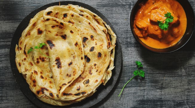 Plate of Indian flatbread served with a curry Plate of Indian flatbread served with a curry