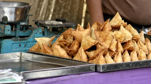 Triangle Samosas stacked on a tray Triangle Samosas stacked on a tray