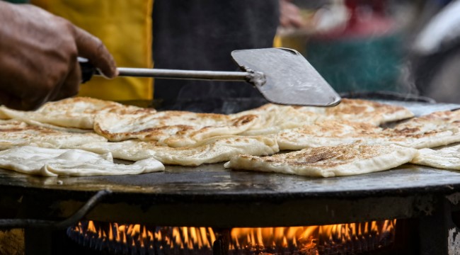 Akki Roti Indian Rice Bread being cooked over flames Akki Roti Indian Rice Bread being cooked over flames