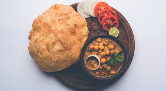 Plate of Chhole Bhature, an Indian chickpea curry served with deep-fried bread Plate of Chhole Bhature, an Indian chickpea curry served with deep-fried bread