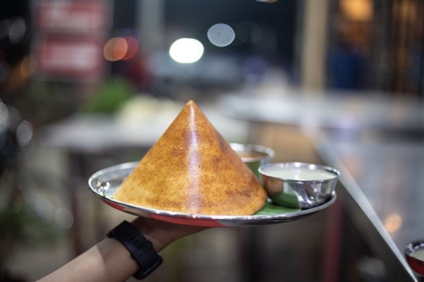 A silver plate of Dosa - an Indian street food classic A silver plate of Dosa - an Indian street food classic