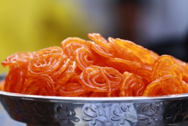 A metal bowl of Jalebi an Indian sweet dish A metal bowl of Jalebi an Indian sweet dish