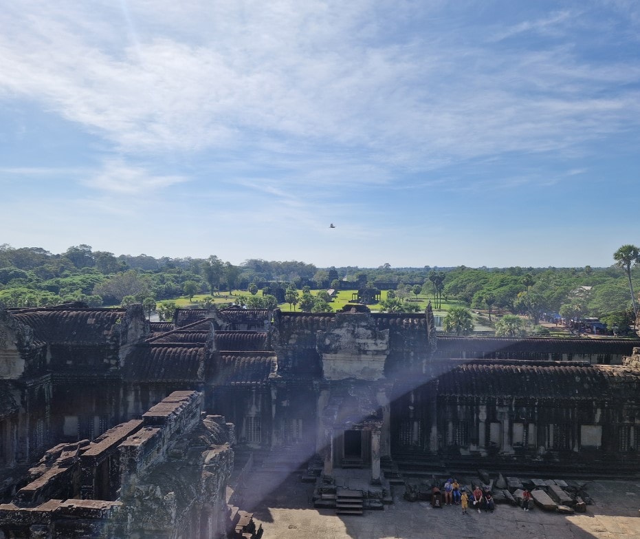 View from the central spire of Angkor Wat over the green grounds. View from the central spire of Angkor Wat over the green grounds.